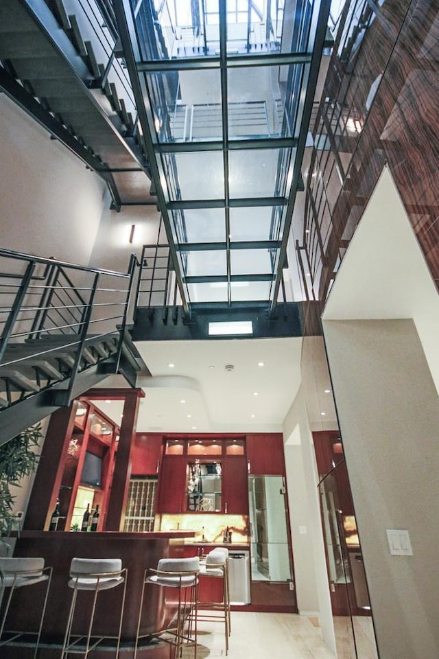 kitchen featuring a towering ceiling and refrigerator