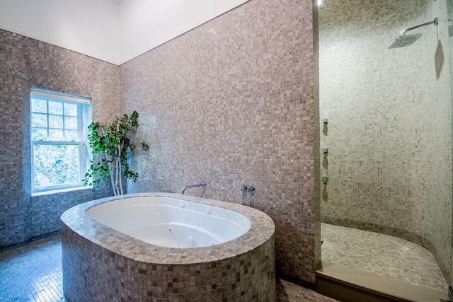 bathroom featuring shower with separate bathtub and tile patterned flooring