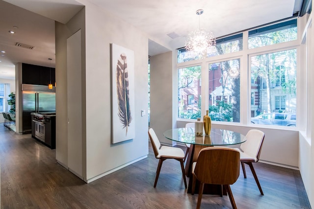 dining space featuring dark hardwood / wood-style floors and a chandelier