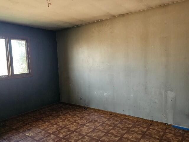 empty room featuring parquet flooring