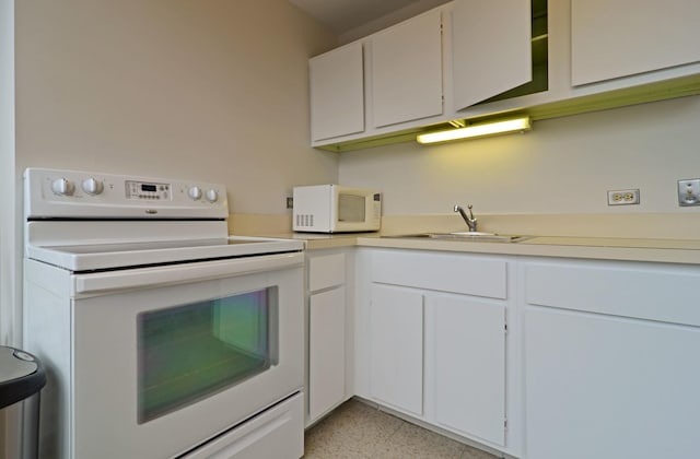 kitchen with white cabinetry, sink, and white appliances