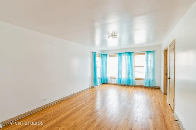 spare room with light hardwood / wood-style flooring