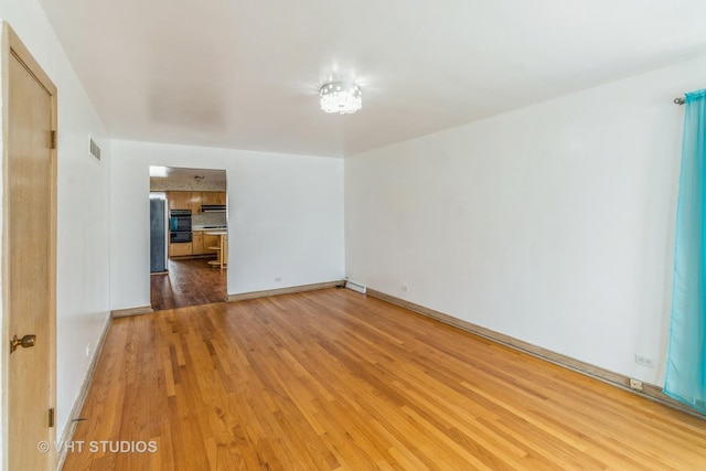 spare room with hardwood / wood-style floors