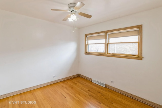 empty room featuring ceiling fan and light wood-type flooring