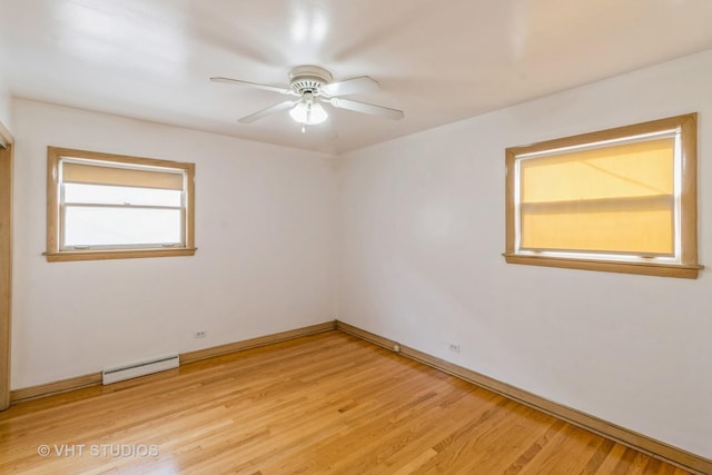 spare room featuring a baseboard heating unit, light hardwood / wood-style flooring, and ceiling fan