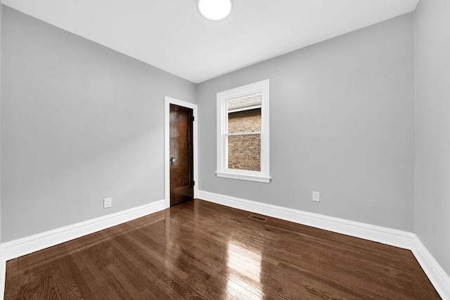 unfurnished room featuring hardwood / wood-style flooring