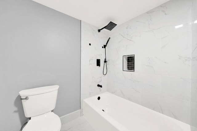 bathroom with tiled shower / bath combo and toilet