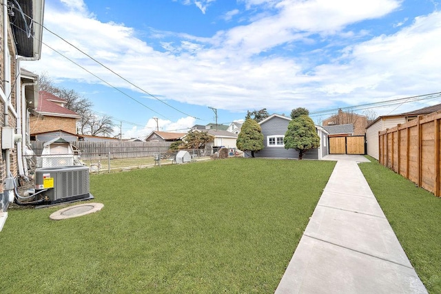 view of yard with a storage shed and central AC