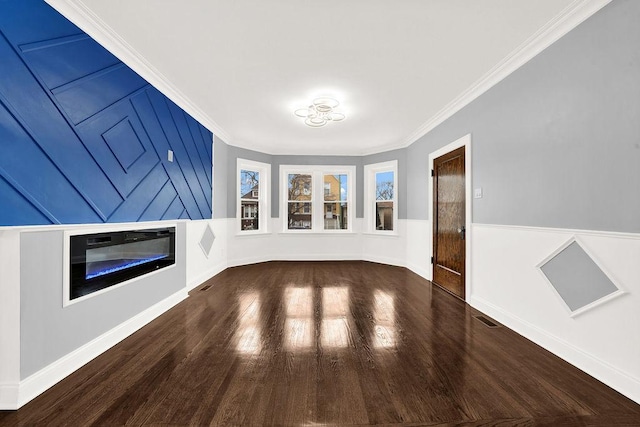 unfurnished living room with crown molding