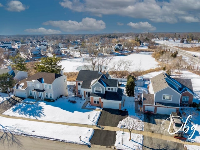 snowy aerial view featuring a residential view