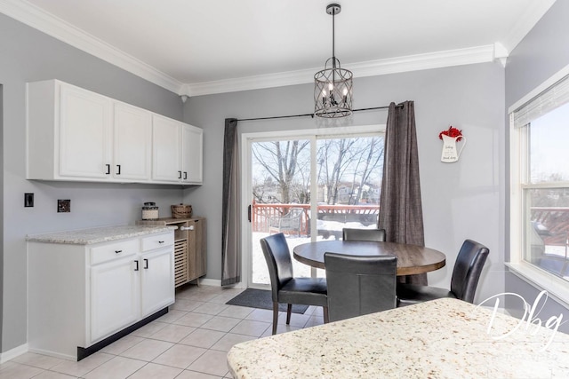 dining space with light tile patterned floors, baseboards, a notable chandelier, and crown molding