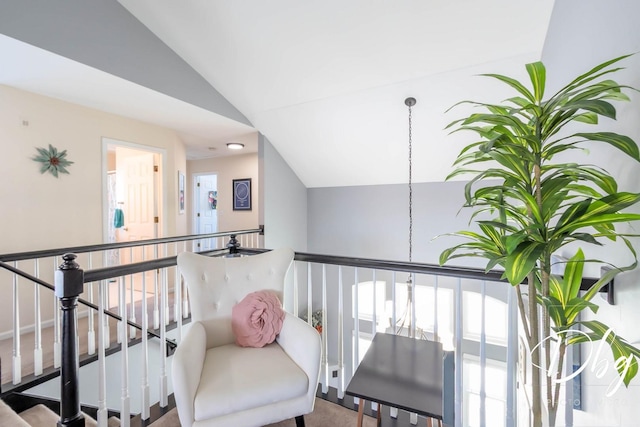 interior space with lofted ceiling and an upstairs landing