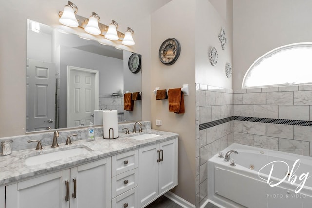 full bath featuring a sink, a tub with jets, and double vanity