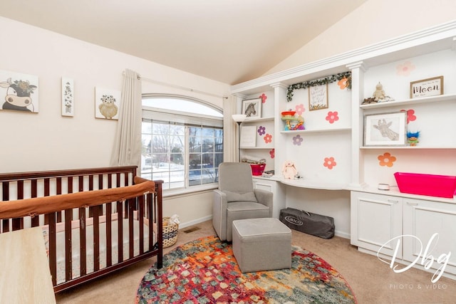 carpeted bedroom with a nursery area, built in study area, vaulted ceiling, and baseboards