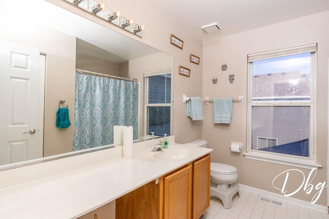 full bathroom with toilet, vanity, baseboards, visible vents, and tile patterned floors