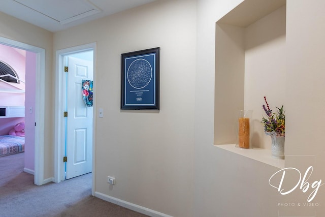 corridor featuring carpet and baseboards