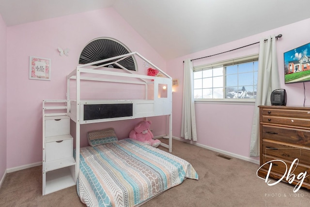 bedroom with vaulted ceiling, carpet floors, visible vents, and baseboards