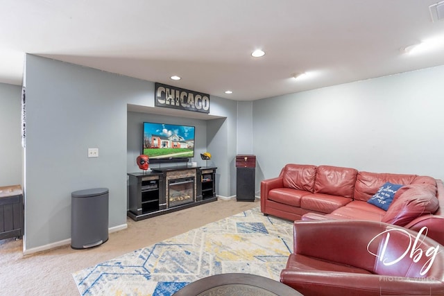 living room with recessed lighting, carpet flooring, visible vents, baseboards, and a glass covered fireplace