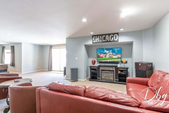 carpeted living room featuring recessed lighting, a glass covered fireplace, and baseboards