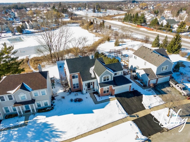 snowy aerial view featuring a residential view