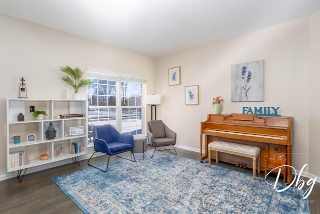 sitting room featuring baseboards and dark wood-type flooring