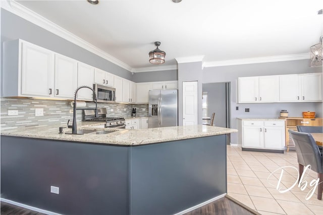 kitchen featuring appliances with stainless steel finishes, crown molding, backsplash, and light stone counters