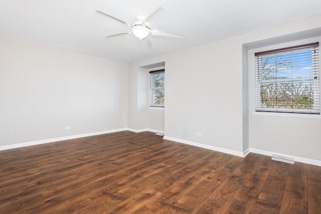 empty room featuring dark hardwood / wood-style floors and ceiling fan