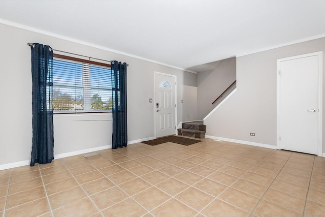 entrance foyer with light tile patterned floors and crown molding