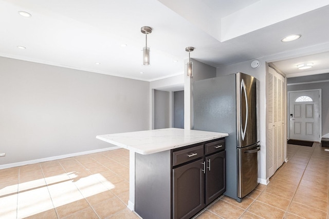 kitchen featuring ornamental molding, pendant lighting, stainless steel refrigerator, and light tile patterned flooring