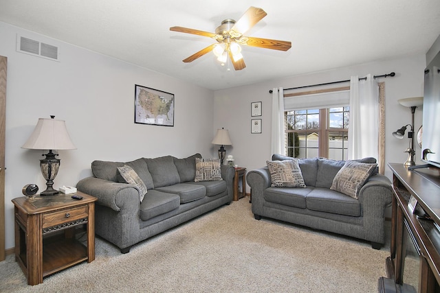 carpeted living room with ceiling fan