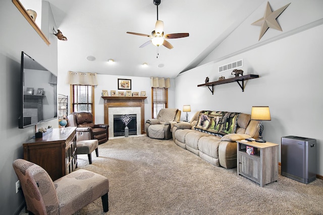 living room featuring ceiling fan, a fireplace, carpet flooring, and high vaulted ceiling