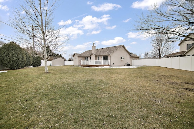 back of house featuring a wooden deck, a patio area, and a lawn