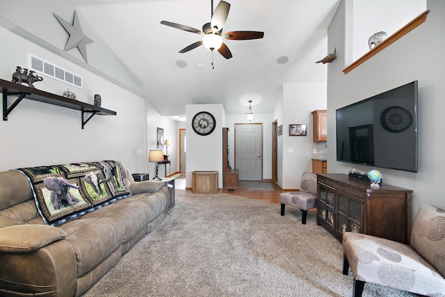 carpeted living room with high vaulted ceiling and ceiling fan