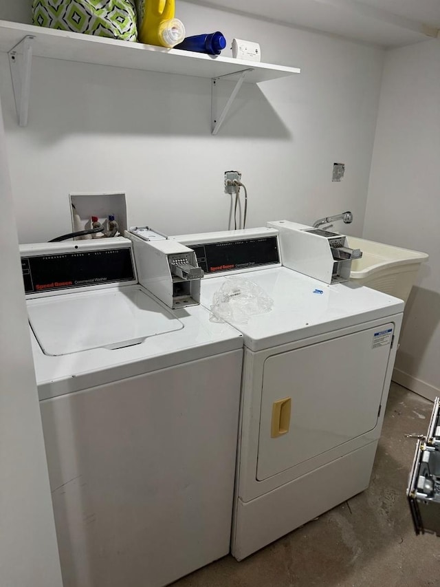 laundry room with separate washer and dryer and sink