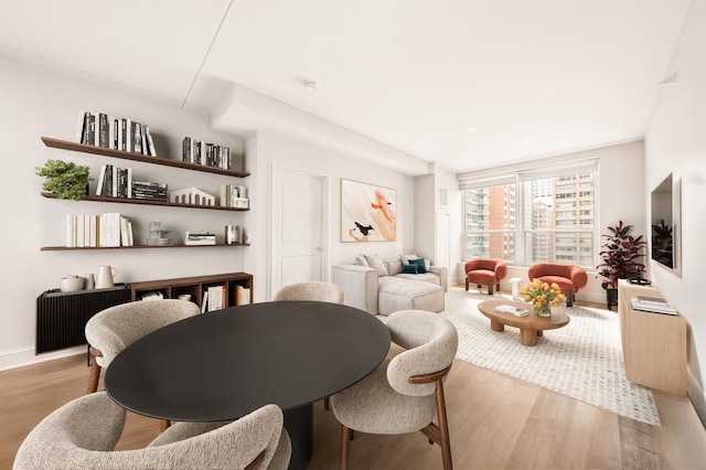 dining area featuring wood finished floors and baseboards