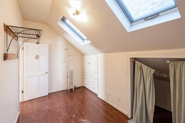 bonus room with lofted ceiling, dark hardwood / wood-style flooring, and radiator heating unit