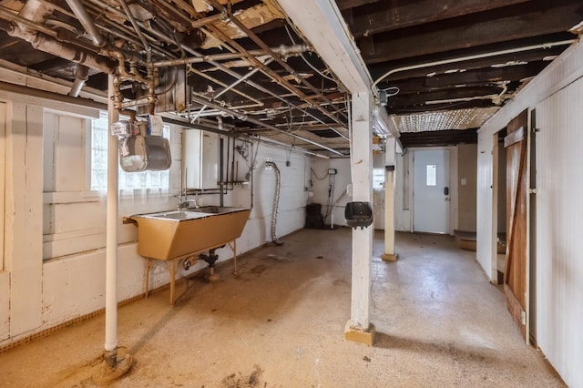 basement with a healthy amount of sunlight and sink