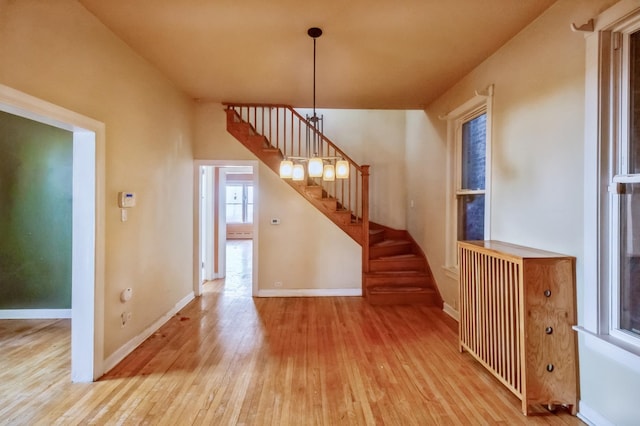 interior space with radiator and light hardwood / wood-style flooring