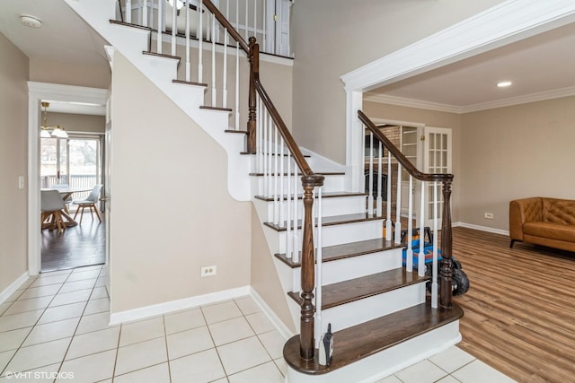 stairs featuring tile patterned flooring and crown molding