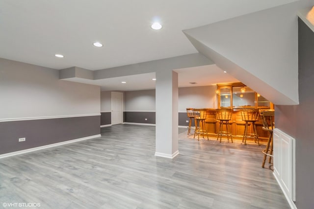 interior space featuring bar area and light wood-type flooring