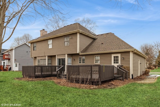 rear view of property featuring a yard and a deck