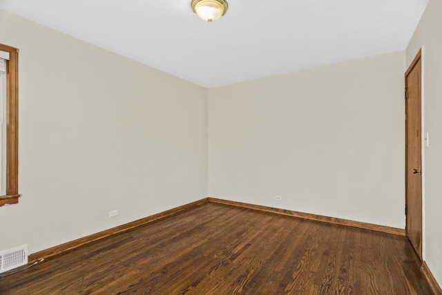 unfurnished room with dark hardwood / wood-style flooring