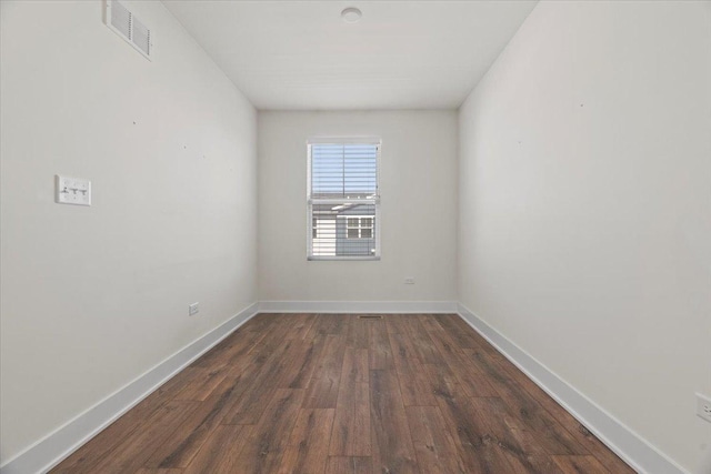 unfurnished room with dark hardwood / wood-style floors