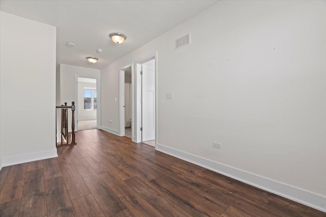 empty room featuring dark hardwood / wood-style flooring