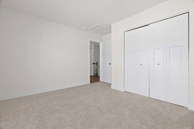 unfurnished bedroom with light carpet and a closet