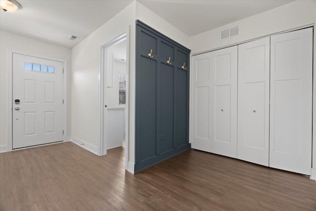 entryway with dark hardwood / wood-style flooring