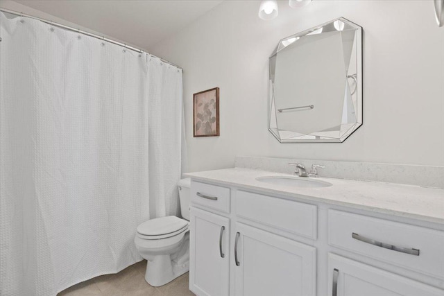 bathroom with vanity, tile patterned floors, and toilet