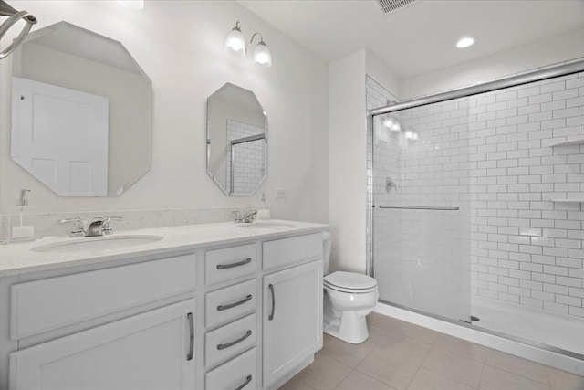 bathroom featuring vanity, toilet, tile patterned flooring, and a shower with door