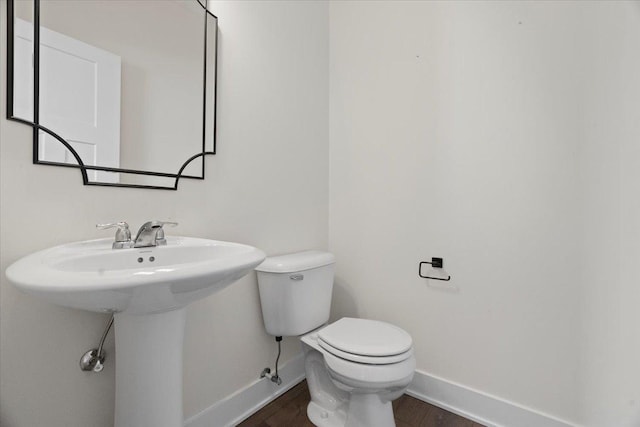 bathroom with wood-type flooring and toilet