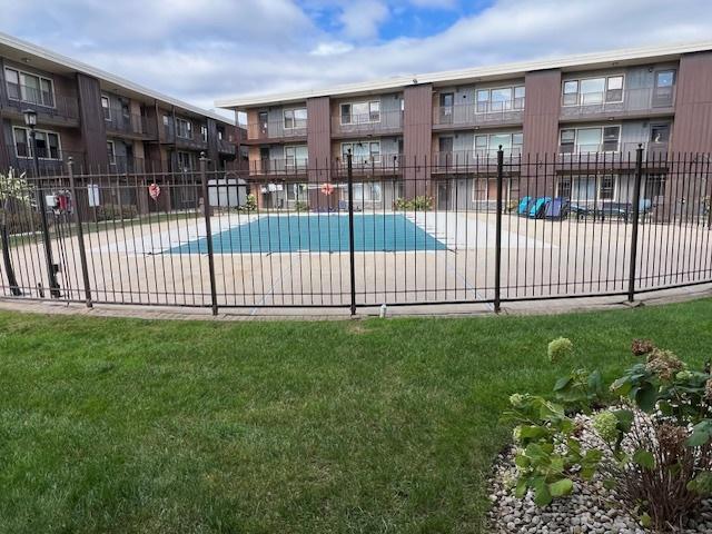 view of swimming pool featuring a yard and a patio area